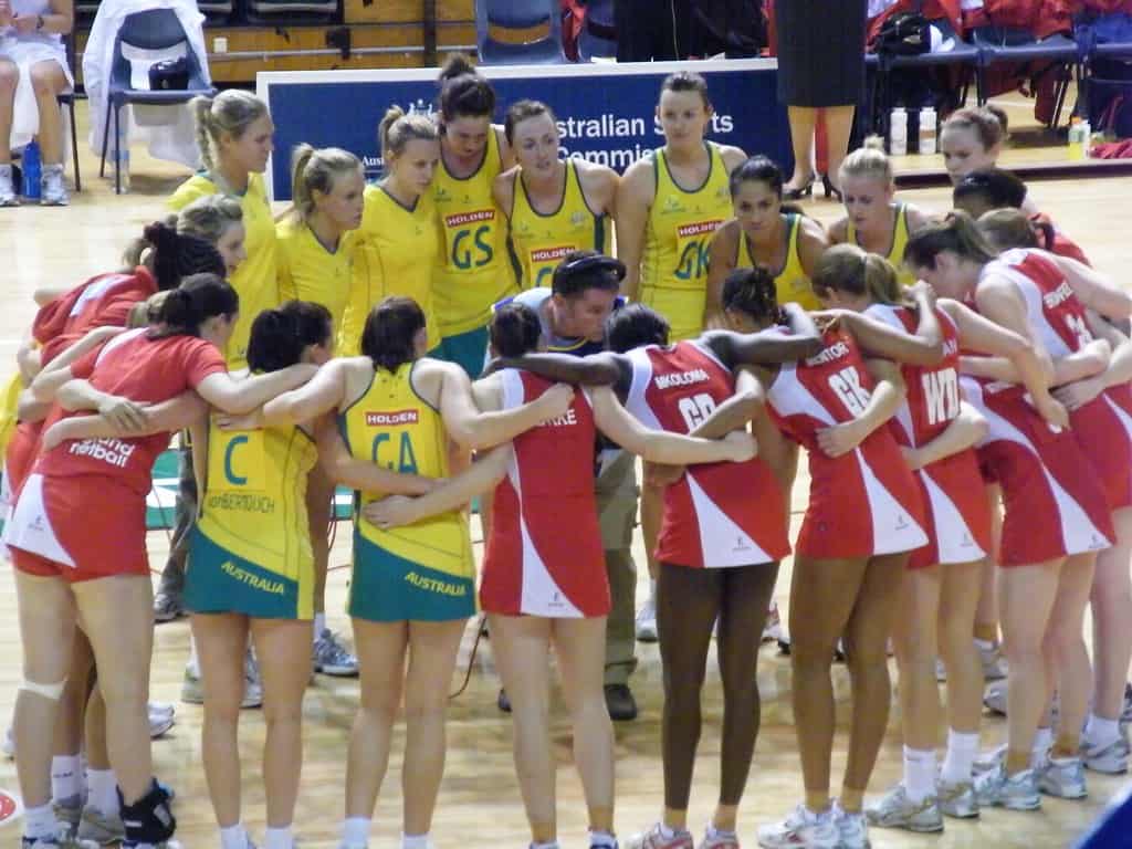 England and Australian netball players in a huddle